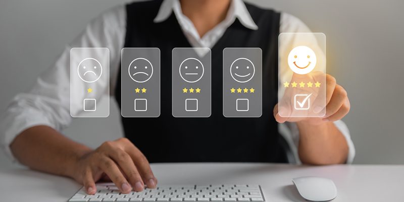 Businessman pressing face emoticon rating on virtual touch screen to service experience. Customer service and Satisfaction concept.